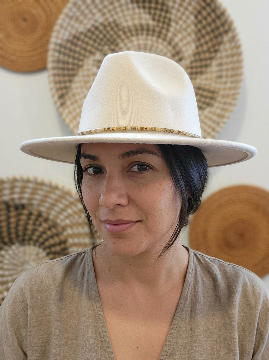 woman wearing handcrafted hat band made of genuine 4x2mm Jasper beads on a cotton cord with adjustable leather ties.